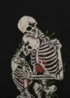 a skeleton holding a rose in its hand