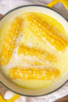 corn on the cob being cooked in a skillet