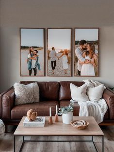 a living room filled with furniture and pictures hanging on the wall above a coffee table