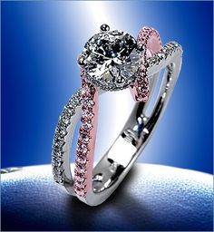 a diamond ring with pink and white diamonds on it's sidestrap, in front of a blue background