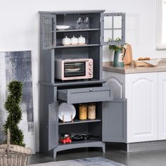 a microwave oven sitting on top of a wooden cabinet