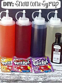 some bottles and candy are sitting on a table with the words diy snow cone syrup