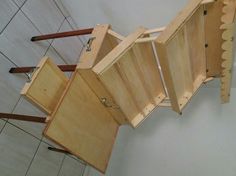 an unfinished kitchen cabinet sitting on top of a tile floor next to a wooden rack