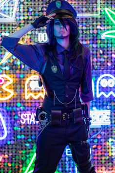 a woman dressed in police gear posing for the camera with her hands on her head