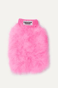 a pink furry dog sweater on a white background