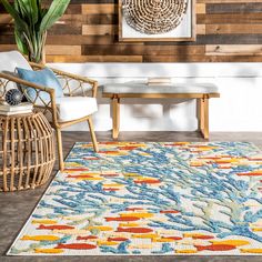 a colorful rug in front of a wooden wall with a chair and table next to it