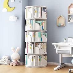 a child's room with blue walls and white furniture, including bookshelves