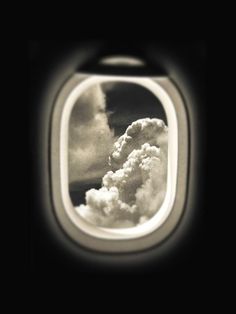 two cats are flying in the sky through an airplane's window, with clouds behind them