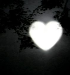 a white heart shaped object in the dark