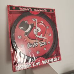 a red and black clock with words on it