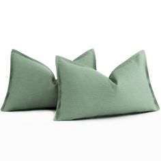 two green pillows sitting on top of each other