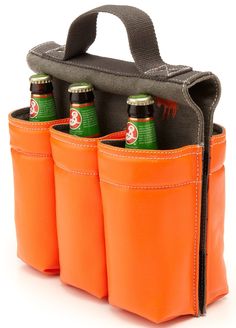 four beer bottles in an orange case on a white background with the top open and bottom closed