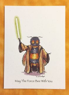 a card with an image of a bee holding a light saber in its hand and saying may the force be with you