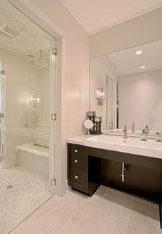 a large bathroom with two sinks and a walk in shower