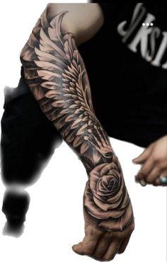 a man's arm with a rose and wings tattoo on the left side of his arm