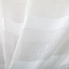 closeup view of white linen fabric with diagonal lines on the top and bottom, as seen from above