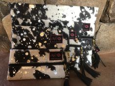 three black and white purses with gold spots on them sitting next to each other