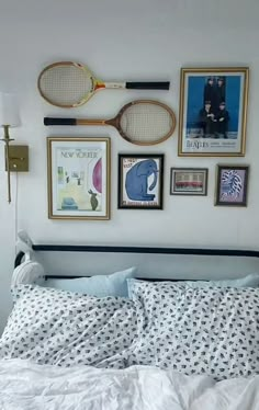 a bedroom with tennis rackets and pictures on the wall