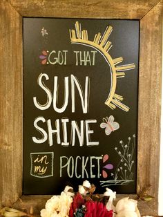 a sign that says, got that sun shine pocket and flowers in front of it