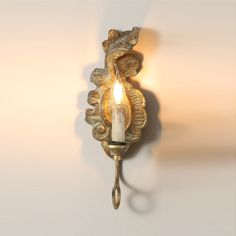 a wall light with a candle on it