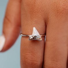 Sink your teeth into the Stone Shark Tooth Ring, designed in partnership with Discovery’s Shark Week. This limited-edition style is set on a delicate silver band, with an enamel shark tooth charm for the ocean-obsessed. For each Shark Week style sold, 5% of the purchase price* will be donated to Oceana, Inc. to help save sharks and protect the oceans, with a minimum donation of $50,000 by April 30th, 2023. - Brass base with rhodium plating & enamel- Shark tooth: 10mm (H) x 10mm (W)- Because jewe Shark Clothes, Shark Tooth Ring, Shark Teeth Jewelry, Kite Accessories, Shark Jewelry, Flower Spinner, Tooth Ring, Tooth Charm, Cute Engagement Rings