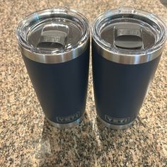 two yeti cups sitting on top of a granite countertop next to each other