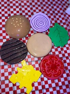 an assortment of cookies and pastries on a checkered tablecloth