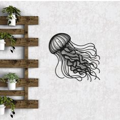 a drawing of a jellyfish on a wall next to potted plants and wooden shelves