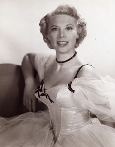 an old black and white photo of a woman wearing a corset