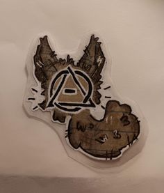 a sticker depicting an animal with the letter a on it's face and another bear in the background