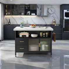 a kitchen with marble counter tops and black cabinets