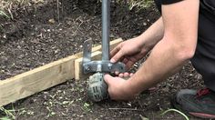 a man is working with some tools in the dirt