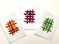 three different colored pieces of paper on top of each other in the shape of arrows