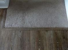 a bathroom with wood floors and white toilet paper on the door way to the bathtub