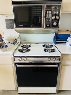 a white stove top oven sitting inside of a kitchen