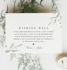 a white card with greenery on it that says wishing well