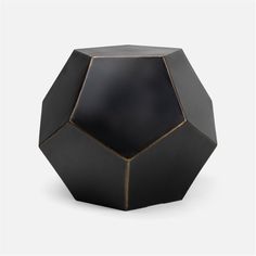 a black and gold vase sitting on top of a table