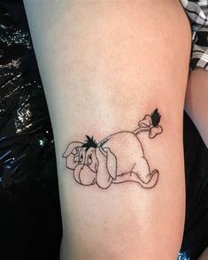 a woman's leg with a tattoo on it that has an image of a dog laying down