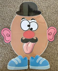 an image of a cartoon character with blue shoes and a hat on the ground in front of a carpet