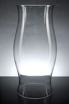 a glass vase sitting on top of a table