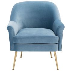 a blue velvet chair with gold legs