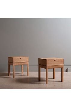 two wooden tables sitting next to each other on top of a hard wood flooring