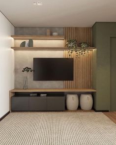 a living room with a large flat screen tv on the wall and two vases