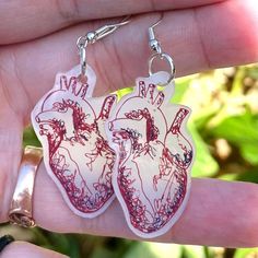 These handmade, lightweight dangle earrings beautifully capture the intricate details of the human heart, making them perfect anatomy earrings for any medical professional. As unique nurse earrings, they serve as a thoughtful gift for a heart doctor, blending style with a passion for healthcare. Features: Unique Design: Each earring showcases an anatomically accurate heart. Handmade Quality: Crafted with care, these earrings are made from durable shrink plastic, ensuring they're lightweight and Human Heart Earrings, Anatomy Earrings, Heart-shaped Surgical Steel Jewelry As Gift, Heart-shaped Surgical Steel Jewelry Gift, Nurse Earrings, Heart Anatomical, Realistic Heart, Unique Heart-shaped Earrings For Valentine's Day, Heart Surgeon