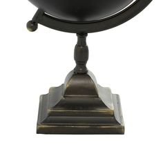 a black globe on a stand against a white background