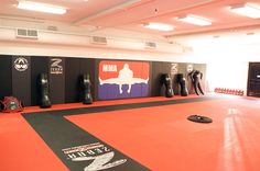 an empty gym with several punching pads on the floor