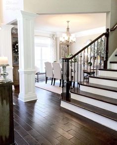 a living room with hardwood floors and white walls