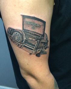 an old fashion car tattoo on the arm