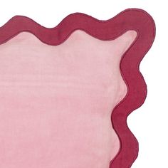 a pink and red placemat with an oval border around it on a white background