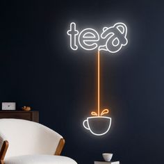 a neon sign that says tea with a coffee cup on it